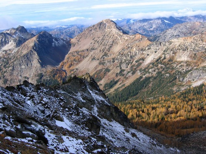 As we climbed higher, we moved from dry sunny rocks to shadowy snowy rocks.
In the background are Choral on the left and Gopher in the middle.
Alas,this was our last clear view of any peaks to the west.  The clouds were spreading faster than we could climb.